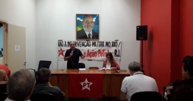 mesa do debate com foto do lula ao fundo